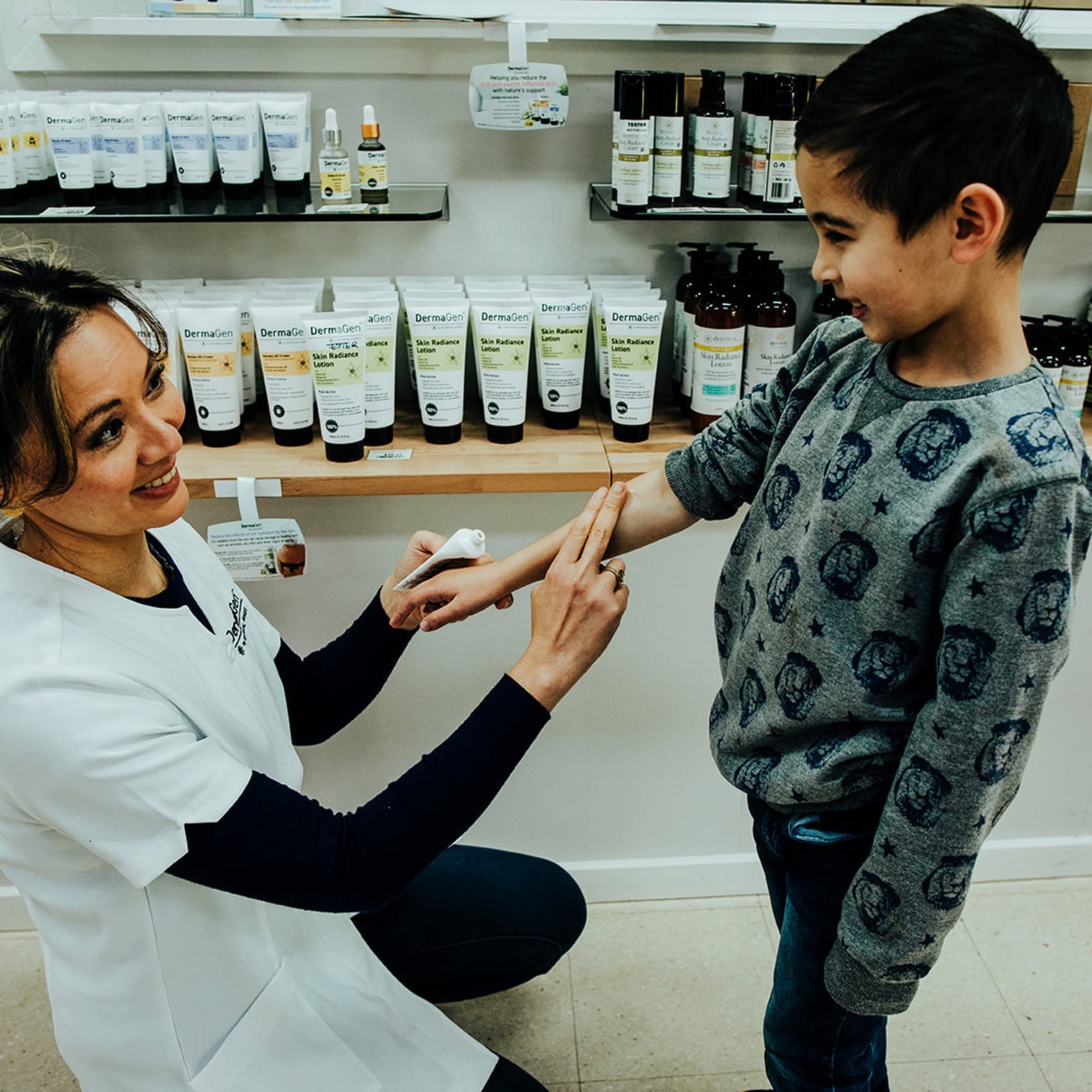 Karen from DermaGen applying Skin Radiance Lotion in store